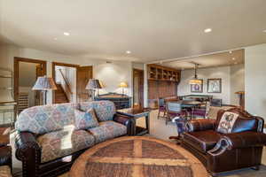 Carpeted living room with billiards