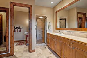 Bathroom with vanity and a shower with shower door