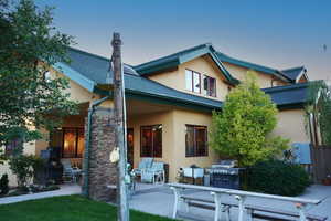 Back house at dusk with a patio