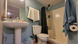 Bathroom featuring walk in shower and toilet