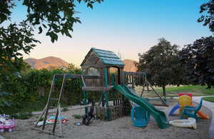 Playground at dusk featuring a mountain view