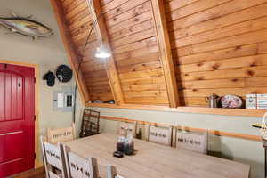 Dining space featuring wood ceiling and vaulted ceiling with beams