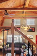 Interior space with wood-type flooring, vaulted ceiling with beams, ceiling fan, and wooden ceiling