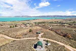 Birds eye view of property with a water and mountain view