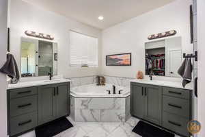 Bathroom featuring independent shower and bath and vanity