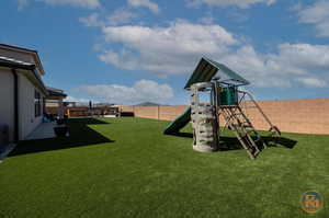 View of playground featuring a yard