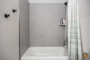 Bathroom with shower / tub combo with curtain