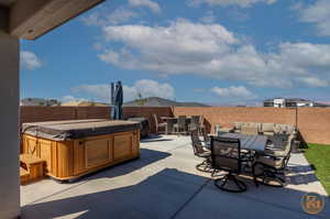 View of patio with a hot tub