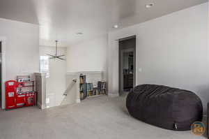 Living area with a notable chandelier, carpet, and a textured ceiling