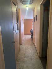 Hallway with light tile patterned flooring