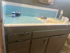 Bathroom #1 featuring backsplash and tile patterned floors