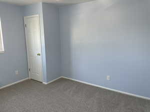 Empty room featuring carpet flooring