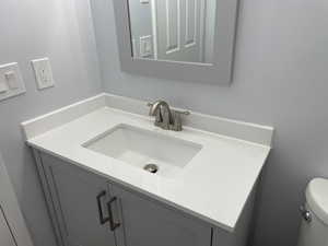 Bathroom featuring vanity and toilet