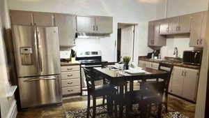 Kitchen with stainless steel appliances, extractor fan, and sink