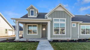 View of front of home with a garage and a front lawn