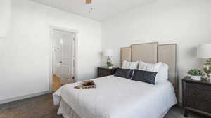 Carpeted bedroom featuring ceiling fan