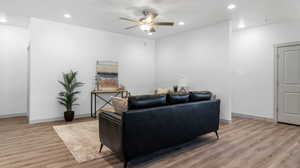 Living room featuring wood-type flooring and ceiling fan