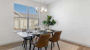 Dining room with a notable chandelier and hardwood / wood-style flooring