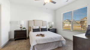 Carpeted bedroom featuring ceiling fan