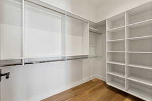 Walk in closet featuring wood-type flooring