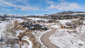 Snowy aerial view featuring a mountain view