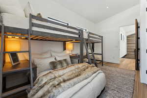 Bedroom featuring vaulted ceiling and hardwood / wood-style floors