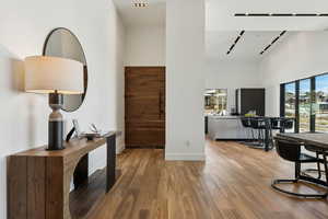 Interior space featuring hardwood / wood-style flooring and a high ceiling