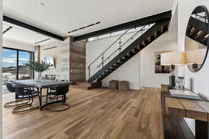 Dining room with beam ceiling and hardwood / wood-style flooring