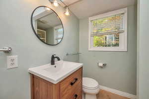 Bathroom with tile patterned floors, vanity, and toilet