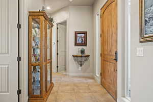 Foyer entrance featuring light tile patterned floors