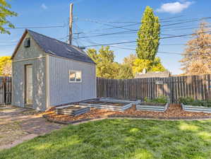 Exterior space with a yard and garden beds