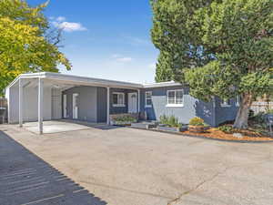 Single story home featuring a carport