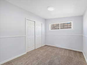 Unfurnished bedroom with carpet floors and a closet