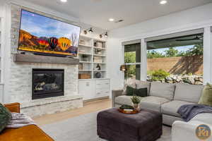 Living room featuring light wood-type flooring and a fireplace