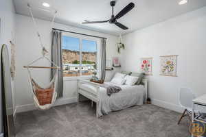 Carpeted bedroom with ceiling fan