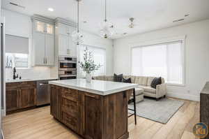 Kitchen featuring light hardwood / wood-style flooring, appliances with stainless steel finishes, and plenty of natural light