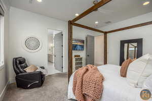 Bedroom with carpet, ornamental molding, ensuite bath, and ceiling fan