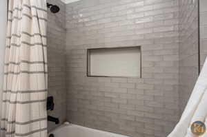 Bathroom featuring shower / bath combination with curtain