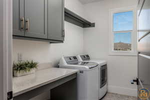 Washroom with cabinets and independent washer and dryer