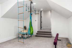 Interior space with lofted ceiling and carpet flooring