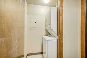 Laundry room with stacked washer / dryer and electric panel