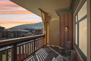 Balcony at dusk featuring a mountain view