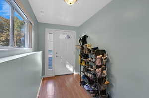 Entrance foyer with light wood-type flooring