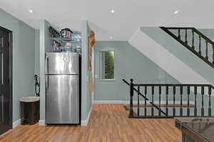 Kitchen with wood-type flooring and stainless steel fridge