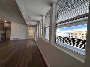 Corridor with dark hardwood / wood-style floors