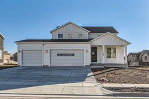 View of front of home with covered porch and a garage