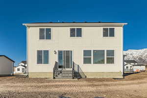 Rear view of property with a mountain view