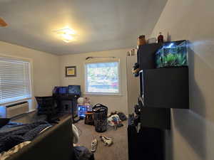 Bedroom featuring cooling unit and carpet flooring