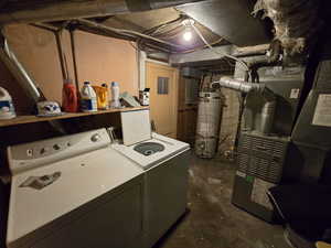 Laundry area with gas water heater and washer and dryer