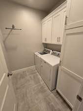 Laundry area with cabinets and independent washer and dryer